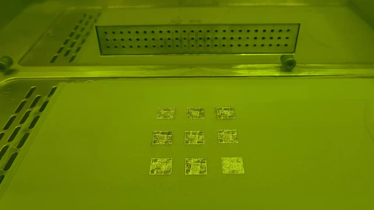 Recoater spreading 316L powder while the laser melts a grid of test cubes on an AO Metal printer