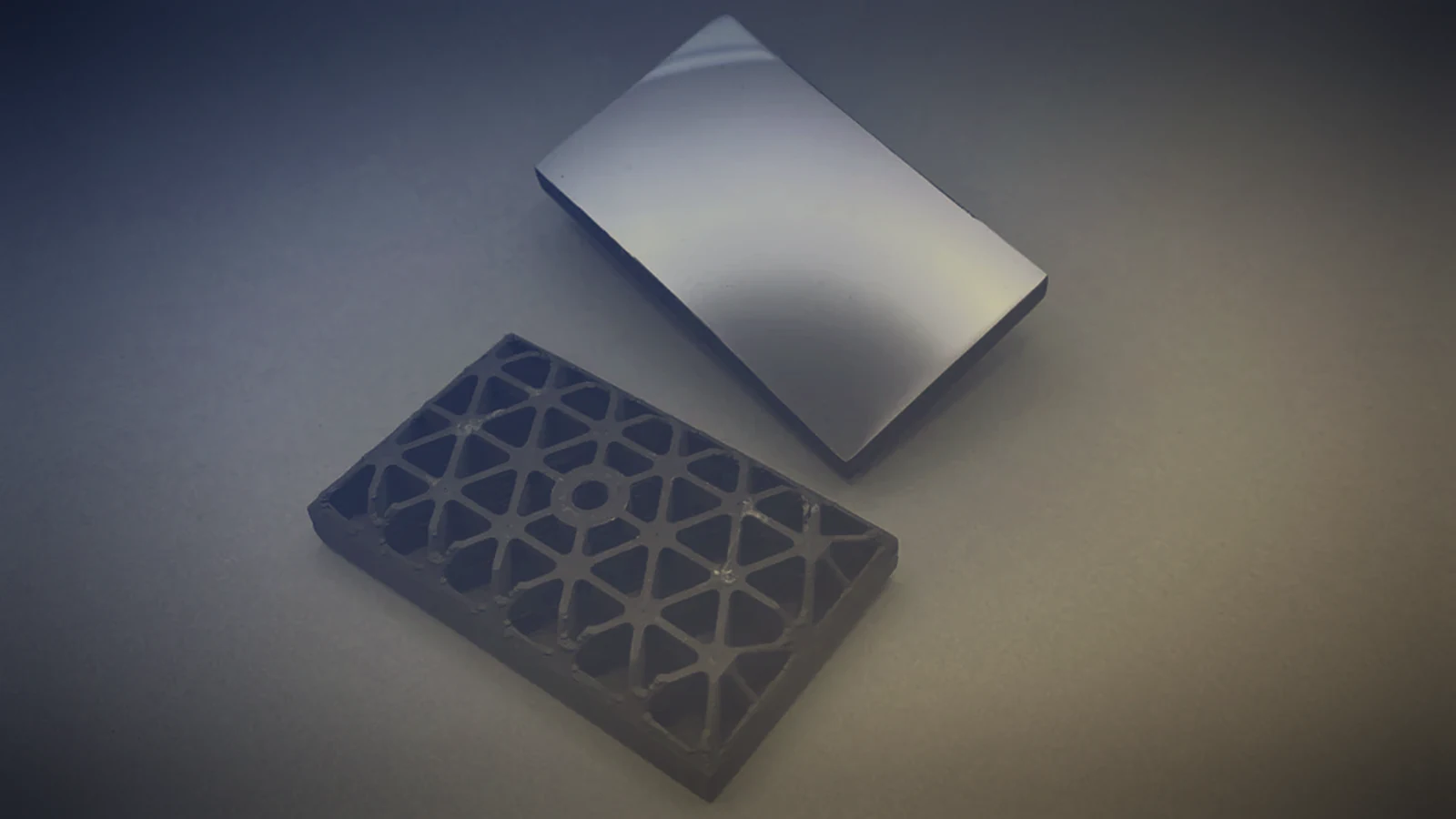 Silicon carbide lattice part 3D printed with ceramic filament and a polished optical mirror on a blue-to-gold graded background, ceramic filament applications