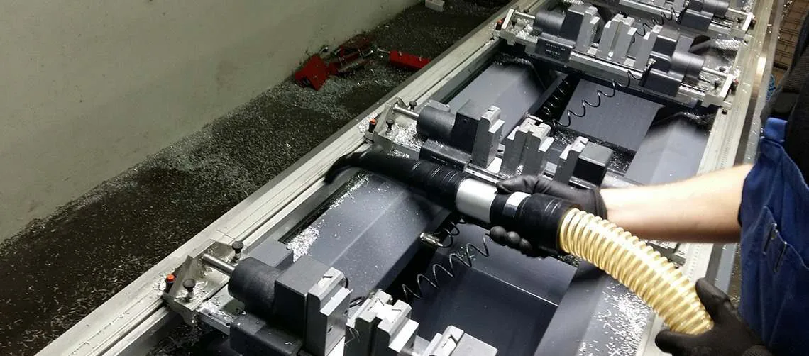 Delfin industrial HEPA vacuum in use capturing fine dust in a workshop