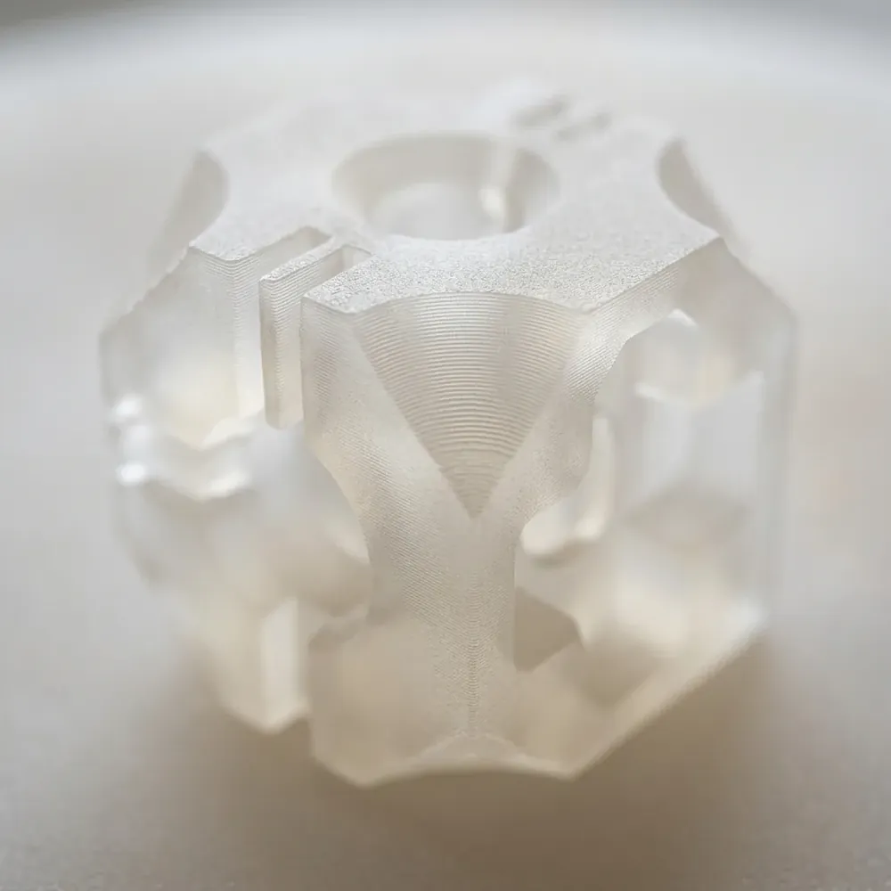 Frosted translucent SLA resin light diffuser glowing on the build platform