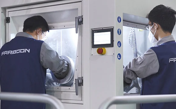 Operators at the glove-box breakout station of the Farsoon FS621M metal LPBF production system