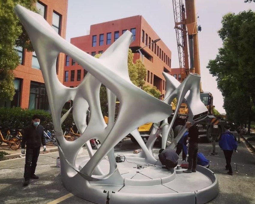 Close-up of a 3D printed architectural model showing building facade on an urban street