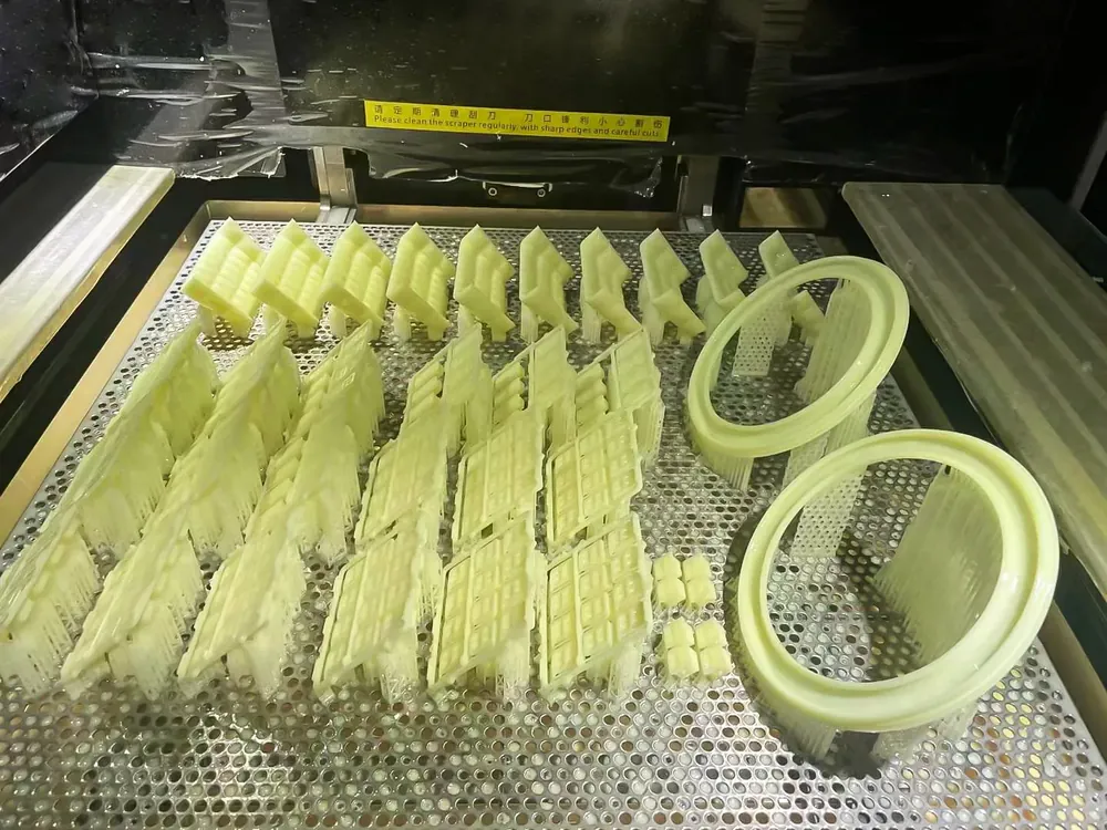 Yellow high-toughness SLA resin automotive grille on the build platform